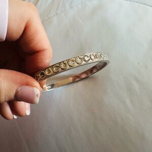 Coach Silver -toned bangle bracelet featuring a "Signature C" pattern
